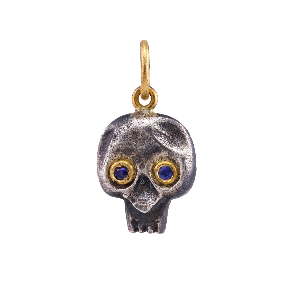 Front-facing view of Blue Sapphire Skull Charm by Prehistoric Works.