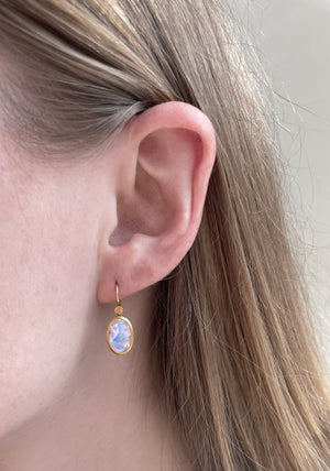 Close-up of model wearing Tiny Oval Moonstone Drop earring by Lola Brooks on left ear