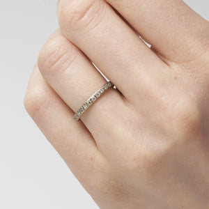 Detail view of model wearing 18k White Gold Diamond Eternity Band by Ruth Tomlinson on left ring finger.