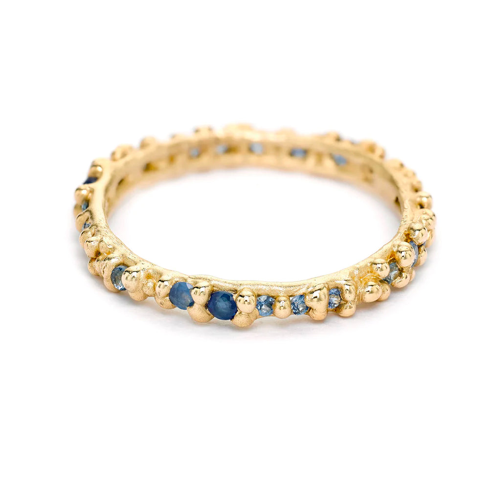 Angled view of Blue Sapphire Granule Eternity Band by Ruth Tomlinson