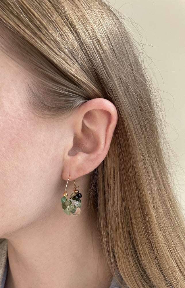 Close-up  view of model wearing Cloud Hoop Earrings with Green Tourmaline by Rachel Atherley on left ear