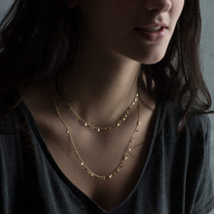 Model wearing Long Random Dots Necklaces by Sia Taylor.