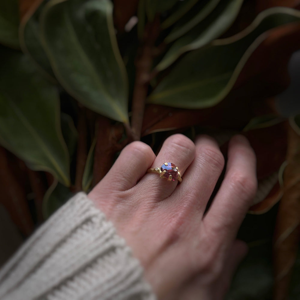 Detail view of model wearing Rhodolite Garnet Rough Luxe Ring by Johnny Ninos on left hand.