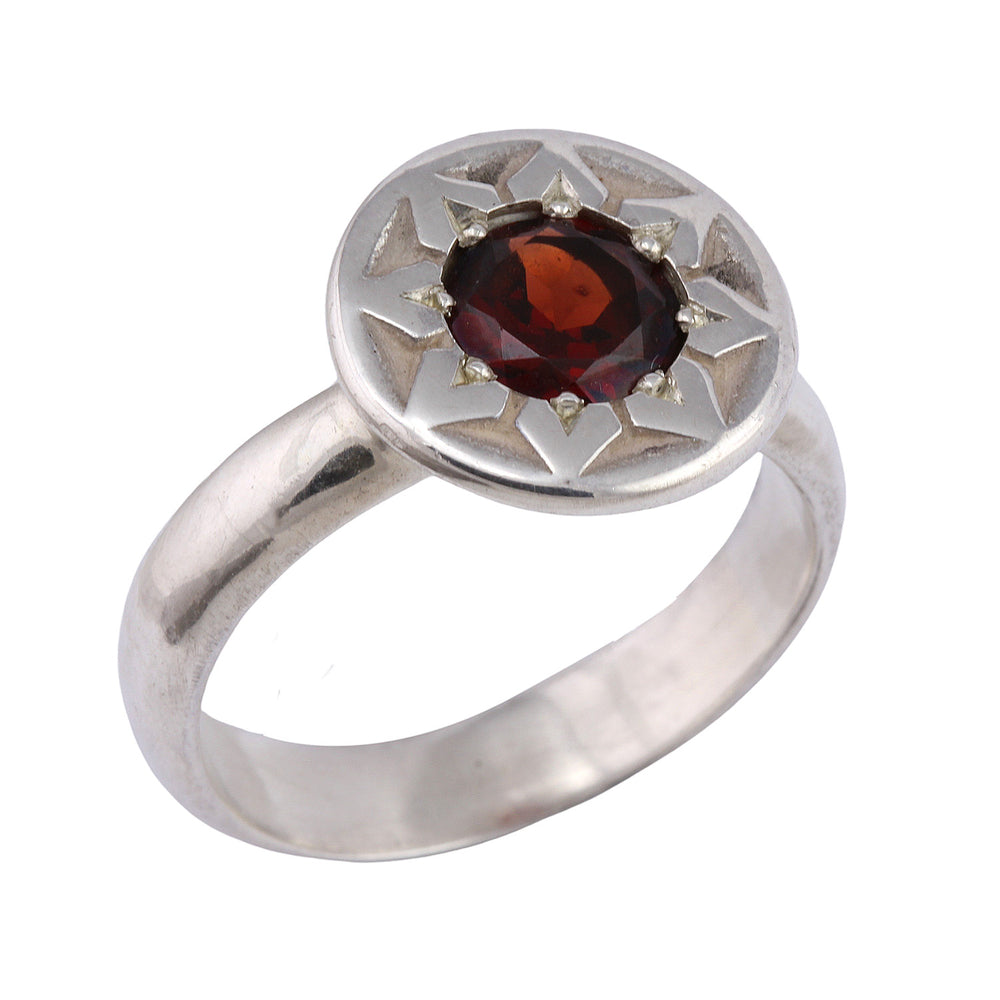 Angled view of ancient Flower Ring by Betsy Barron Jewellery in sterling silver with almandine garnet.