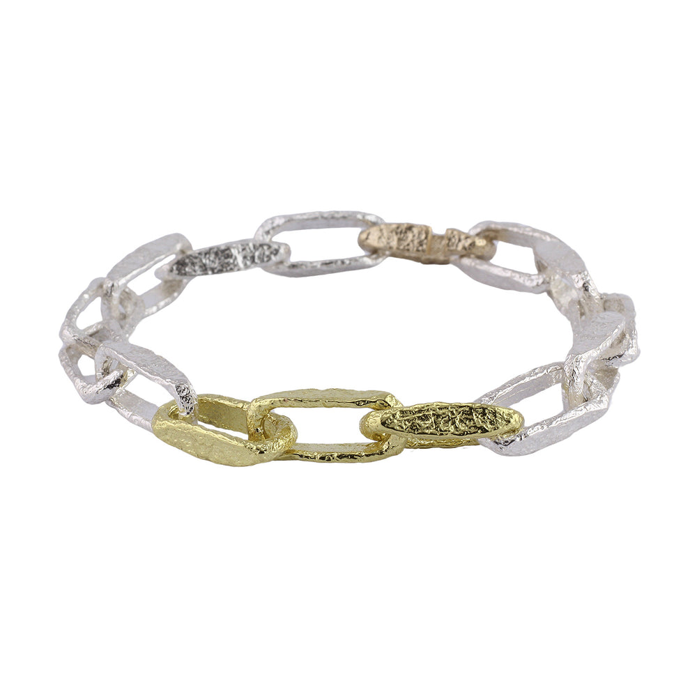 Angled view of Desmond bracelet in sterling silver, 18k yellow gold, and 10k yellow gold, by Betsy Barron