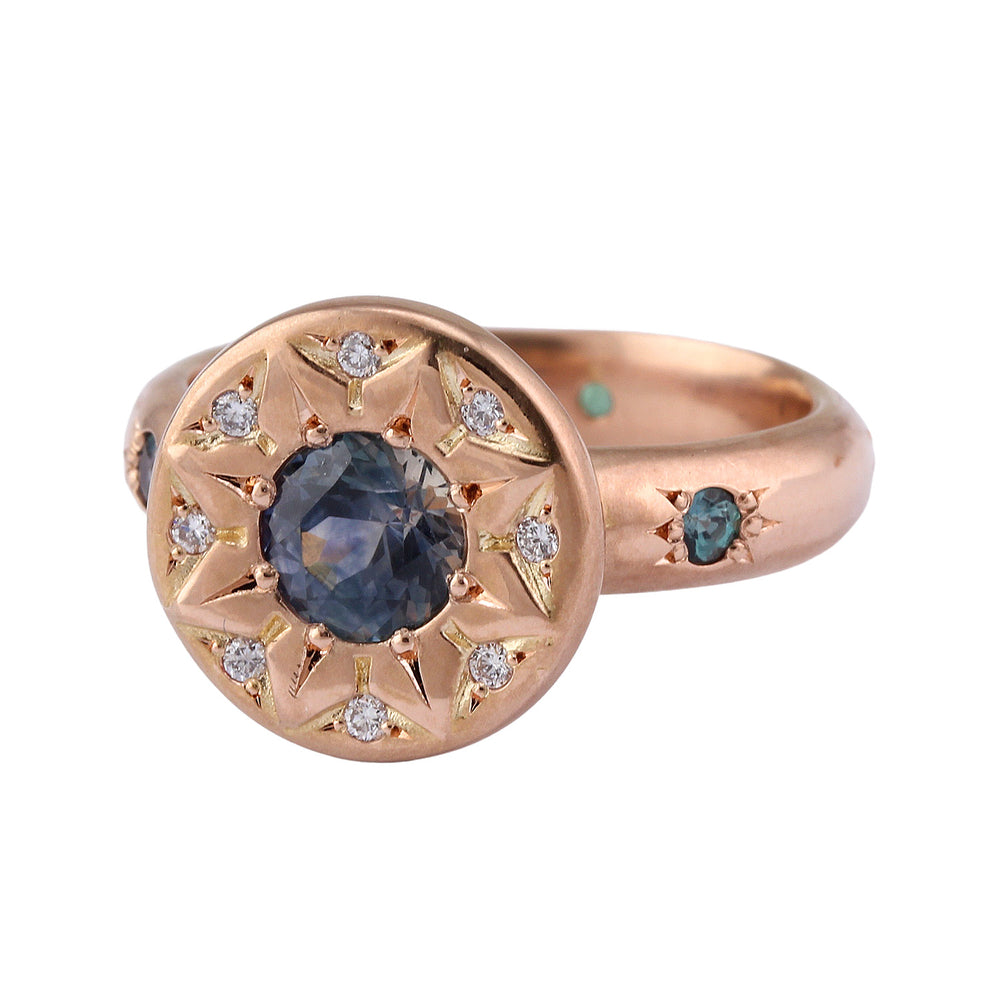 Angled view of Ancient Flower Ring in 18k rose gold with eight white diamonds, one Montana sapphire and five alexandrites by Betsy Barron Jewellery