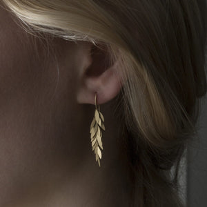 Detail view of model wearing Golden Leaf Earring by Sia Taylor