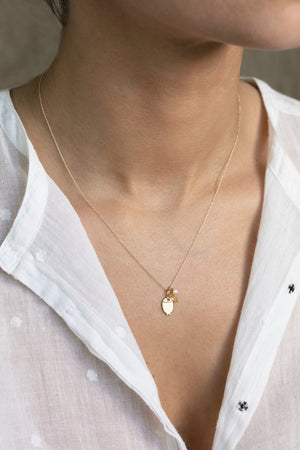Detail view of model wearing Fish Charm Necklace by 5 Octobre