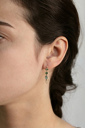 Detail view of model wearing Paola T. Earrings by 5 Octobre