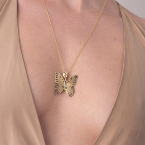 Detail view of model wearing Golden Goliath Birdwing Butterfly Necklace by James Banks