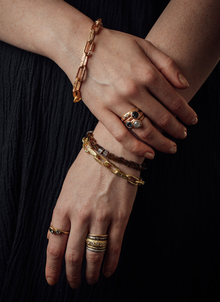 Detail view of model wearing bracelets and rings by Betsy Barron Jewellery.