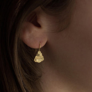 Detail view of model wearing Tiny Golden Hummingbird Cluster Earrings by Sia Taylor