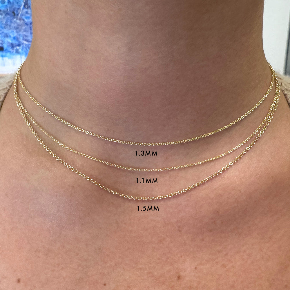 Detail view of model wearing 1.1mm, 1.3mm, and 1.5mm thick cable chain necklaces