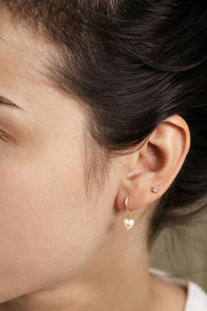 Detail view of model wearing Lola Earring by 5 Octobre on left ear.