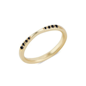 Angled view of Exie Ring in 10k yellow gold with 8 black diamonds.