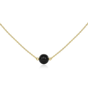
            
                Load image into Gallery viewer, Detail view of Large Onyx Gold Sideways Pendant by Andrea Blais.
            
        