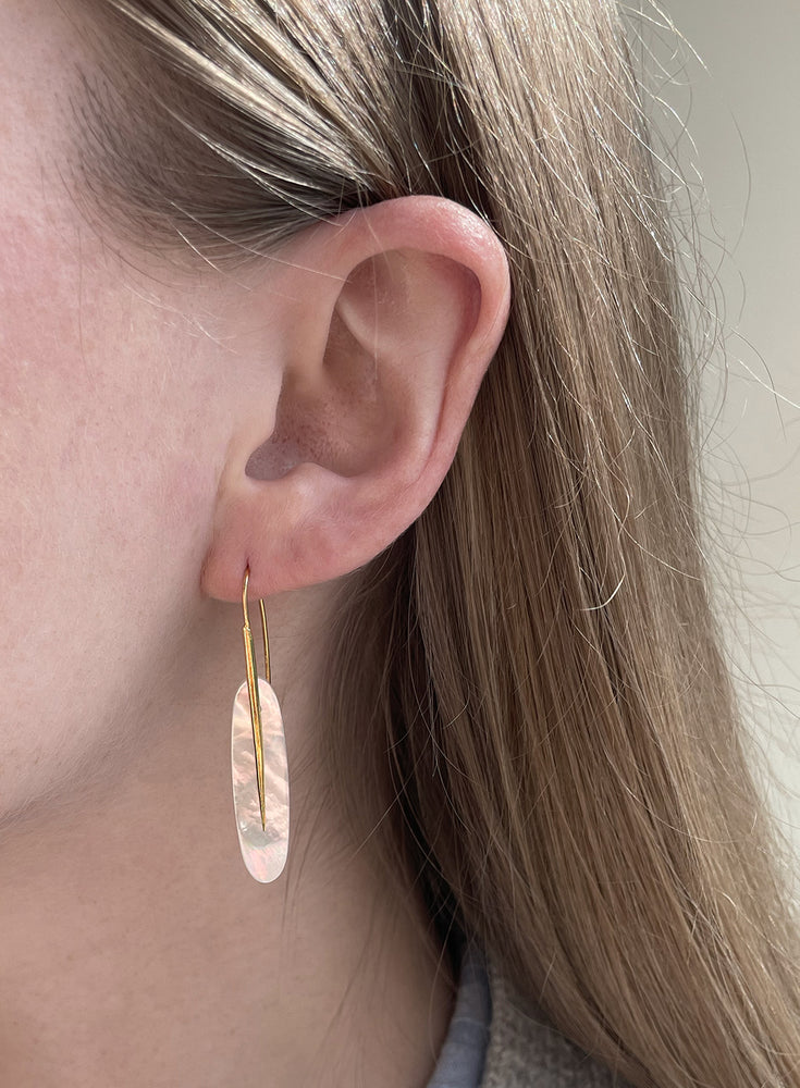 Close-up view of model wearing Medium Feather Earring with White Mother of Pearl by Rachel Atherley on left ear