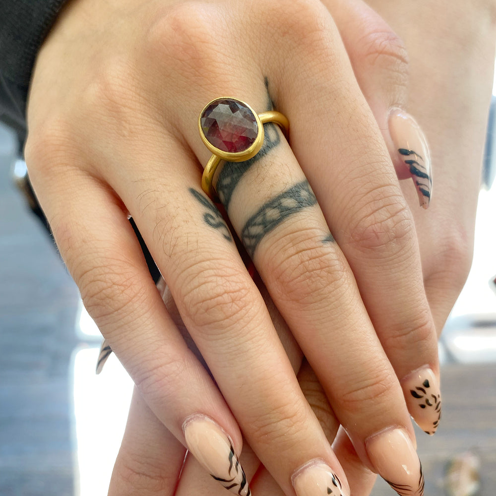 Closeup view of model wearing Oval Orange Natural Sapphire Ring by Lola Brooks on right middle finger.