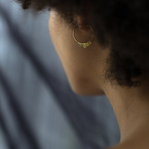 Detail of model wearing Small Rainbow Flutter Hoops by Sia Taylor on left ear.