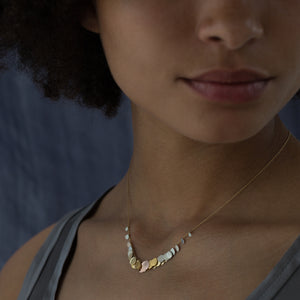 Model wearing Rainbow Hummingbird Necklace by Sia Taylor.