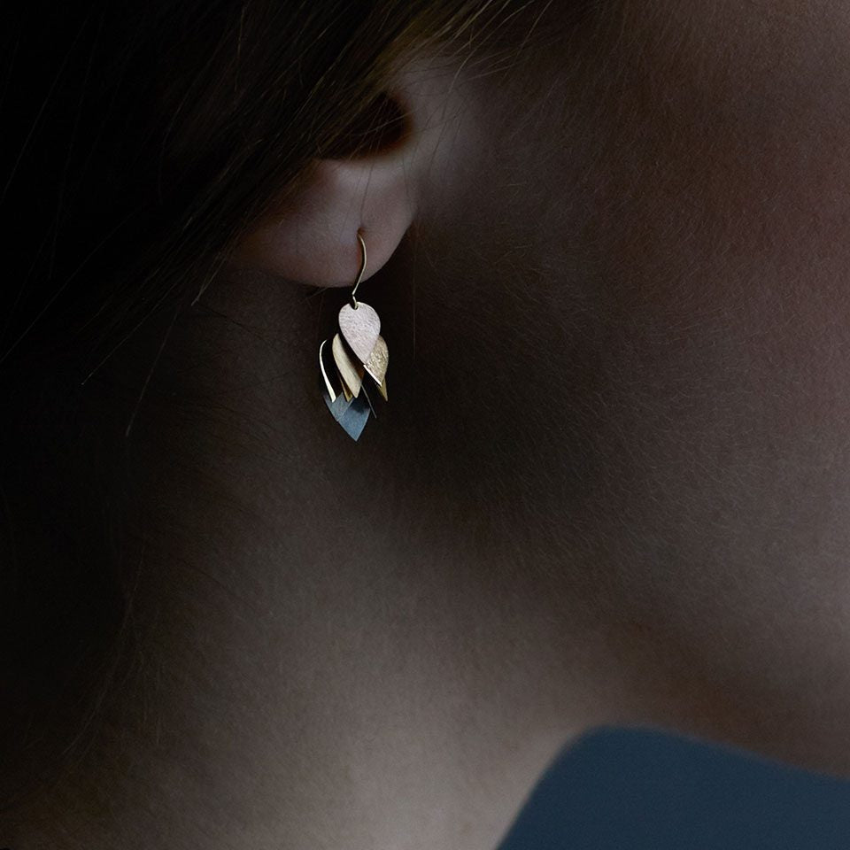 Detail view of model wearing Petal Cluster Earring by Sia Taylor on right ear.