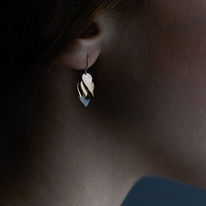 Detail view of model wearing Petal Cluster Earring by Sia Taylor on right ear.
