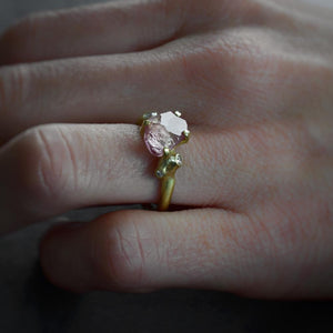 Close up view of model wearing Rough Luxe Pink Garnet Ring by Johnny Ninos on left hand.