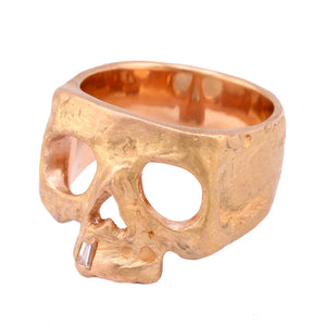  Top-angled view of 18k yellow gold skull ring by Polly Wales.