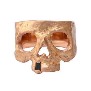 Front-facing view of 20k rose gold Snaggletooth Skull Ring w/ Black Diamond by Polly Wales.